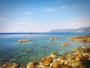 Scenic view of sea against cloudy sky