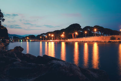 Scenic view of lake against sky at night