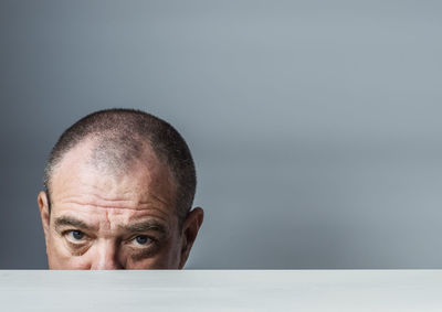 Portrait of man against gray background