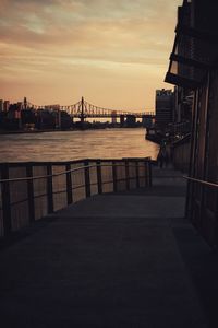 View of bridge over river at sunset