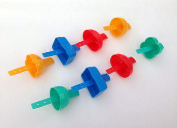 High angle view of multi colored toy on white background