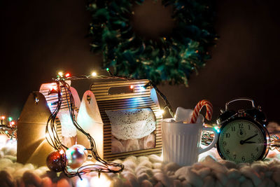 Close-up of illuminated christmas decorations on table at home