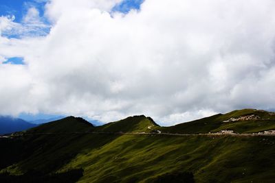 Scenic view of mountains against cloudy sky