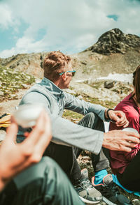 People on mountain against sky