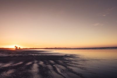 Scenic view of beach against sky during sunset