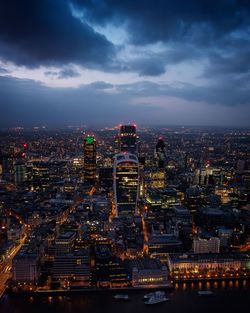 Illuminated cityscape against sky at night