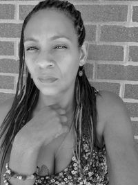 Portrait of woman against wall