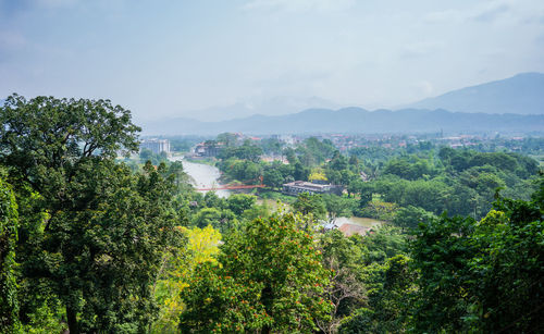 Scenic view of trees and mountains against sky