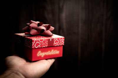 Close-up of hand holding ice cream in box