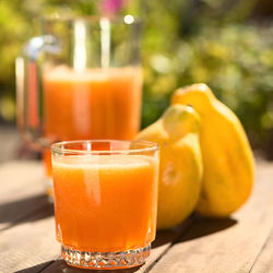 Close-up of orange juice on table