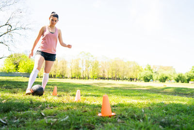 Full length of young woman on field