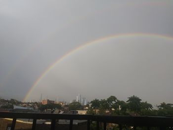 Scenic view of rainbow over buildings in city