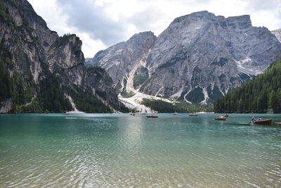 Scenic view of sea and mountains against sky