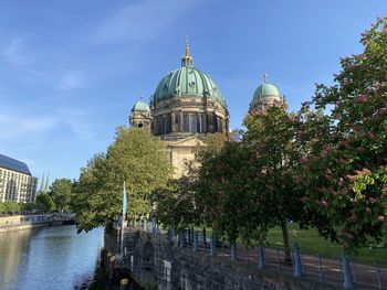 View of trees and buildings against sky