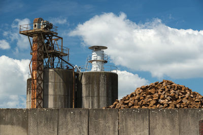 Low angle view of smoke stack against sky