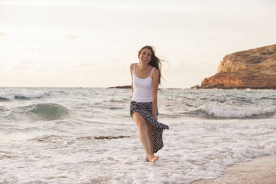 Full length of young woman on beach