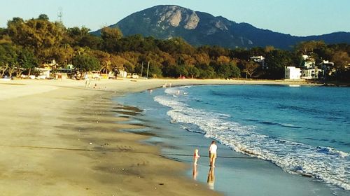 Scenic view of beach against blue sky