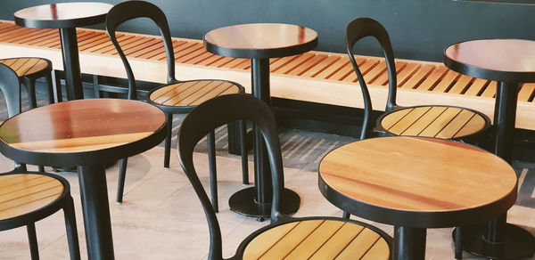 Empty chairs and tables in cafe