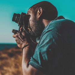 Portrait of young man photographing