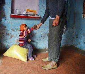 Low section of father with son at home