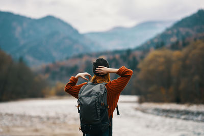 Rear view of man standing on mountain