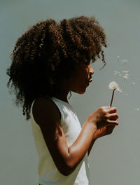 Side view of woman looking at camera