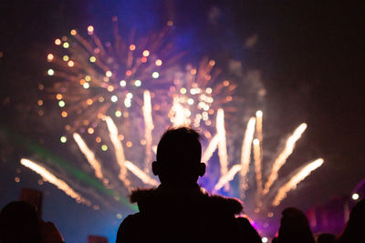 Rear view of silhouette people at music concert