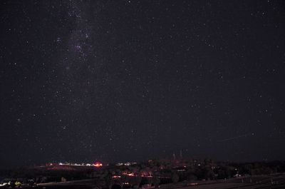 Aerial view of illuminated city against sky at night