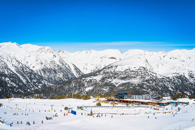 People, families, skiers and snowboarders relaxing and having fun in winter at soldeu, andorra