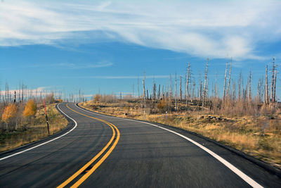 Road passing through landscape against sky