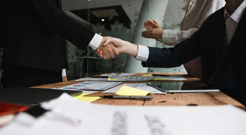 Midsection of business colleagues working at office