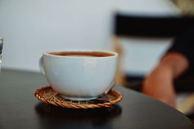 Close-up of coffee cup on table