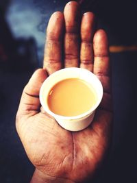 Close-up of hand holding tea cup