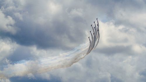 Low angle view of airshow in sky