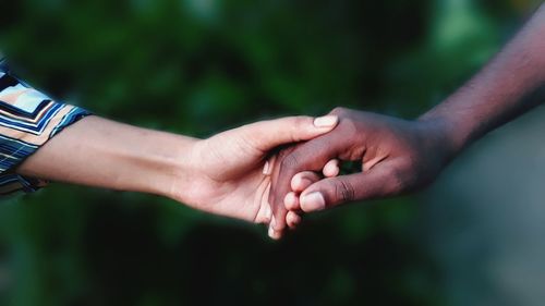 Close-up of couple holding hands