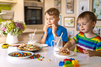 Portrait of boy eating food at home