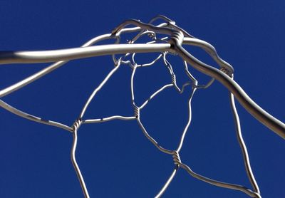 Low angle view of rope against blue sky