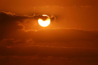 Low angle view of sun in sky during sunset