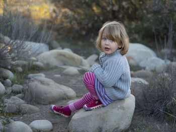 Cute girl sitting in playground