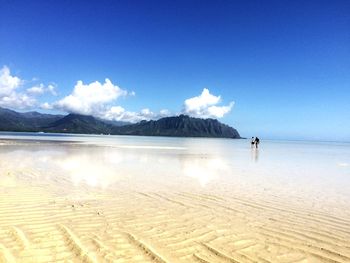 Scenic view of sea against blue sky