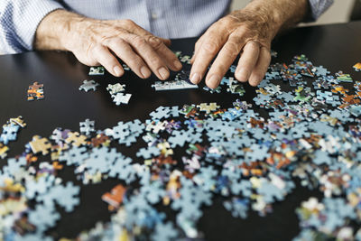 Senior man doing a jigsaw