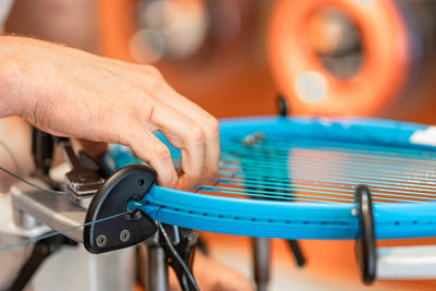 Cropped hand of man repairing bicycle