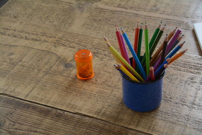 Close-up of colored pencils in container on table