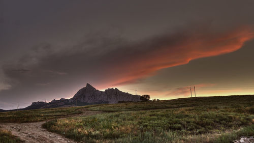 Scenic view of landscape against dramatic sky
