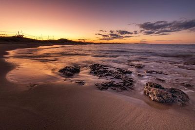 View of beach at sunset