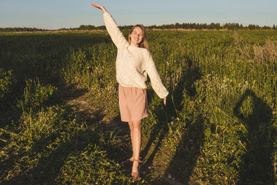 Full length of woman standing on field