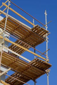 Scaffolding against clear blue sky