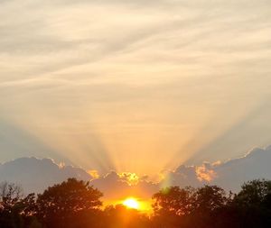 Sunlight streaming through clouds during sunset