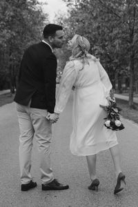 Rear view of couple walking in the garden