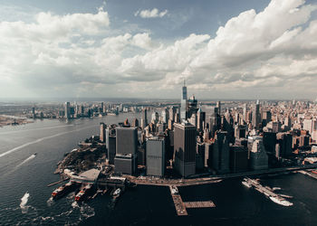 Panoramic view of city buildings against cloudy sky new york city